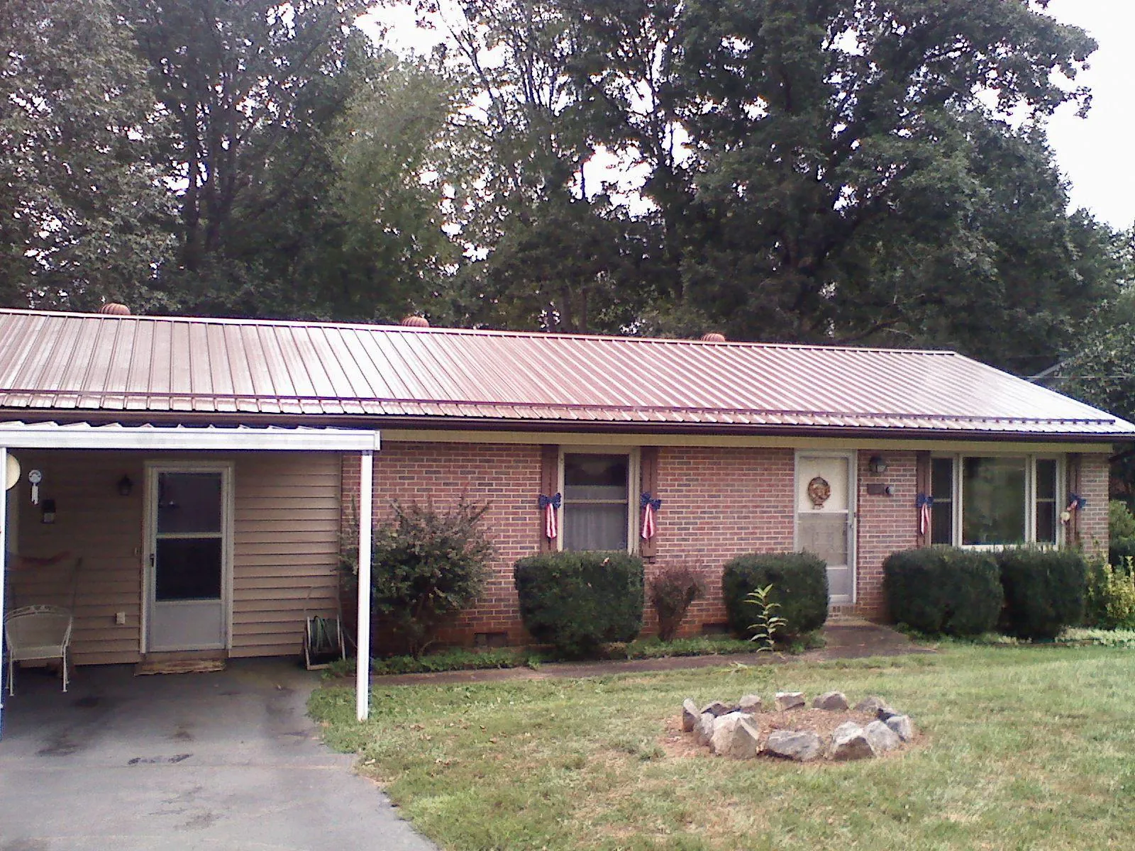 Bronze metal roof and carport on a brick ranch home — Roof Repair work by our crew in Dingmans Ferry